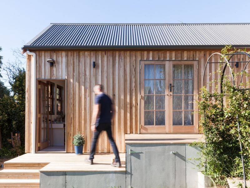 Image of man walking into a tiny home, a secondary residence on a main property