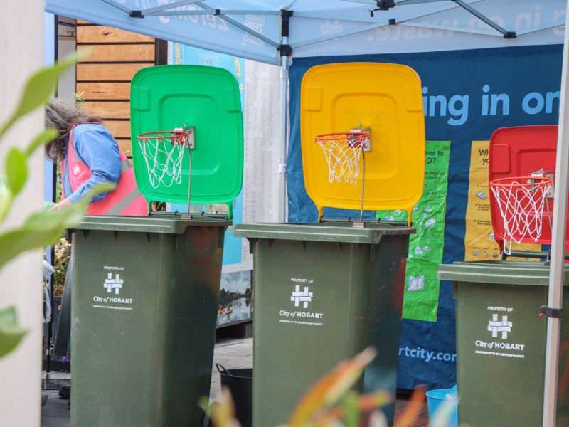 Waste sorting game, three bins like basketball hoops, at waste management strategy pop up