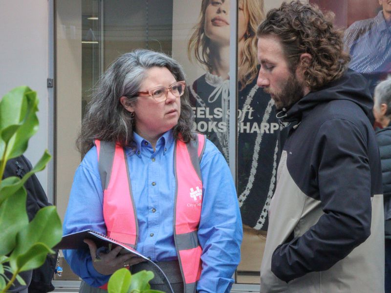 Waste team member talking to man at waste management strategy pop up