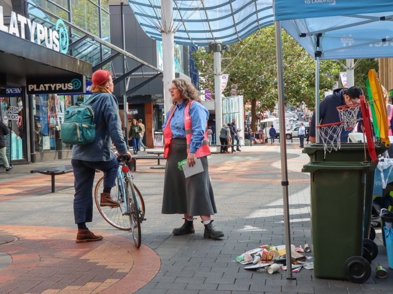 Waste Program Leader. Fiona, talking to community member with bike at waste management strategy pop up
